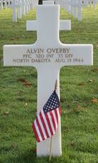 Private First Class Alvin Overby cross grave marker with small American flag photo