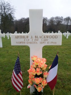 Second Lieutenant Arthur J Blackwood cross grave marker with flags and flowers photo
