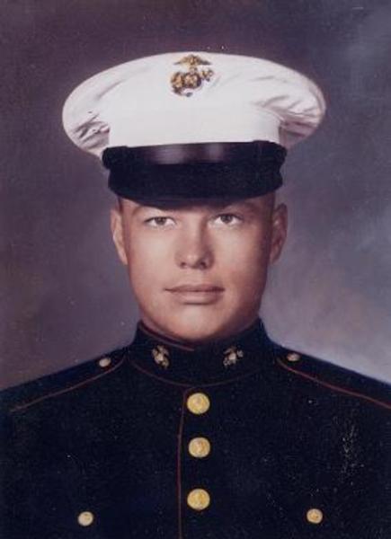 This is a formal United States Marine Corps portrait, showing a Marine in the iconic Dress Blue uniform