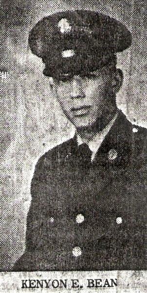 This is a black‑and‑white military portrait of a service member identified as Kenyon E. Bean, shown in what appears to be an older newspaper or printed clipping. The grainy texture and monochrome tones give it the look of mid‑20th‑century print photography.