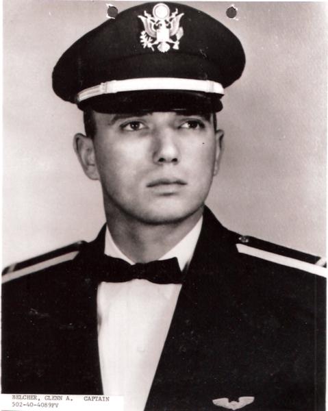 This portrait shows a formal black‑and‑white military photograph of a man identified as Captain Glenn A. Belcher.
