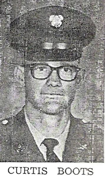 This is a black‑and‑white newspaper‑style military portrait of a service member identified as Curtis Boots.