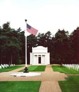 Brookwood Military Cemetery featuring rows of uniform white headstones set among expansive lawns and trees.