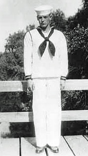 Seaman Second Class Calviin Harry Palmer in uniform standing in front of fence photo