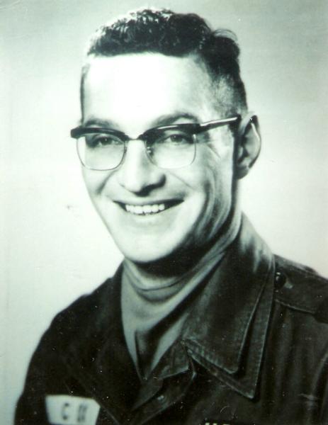This portrait shows a service member in a formal U.S. military uniform, photographed in a classic studio style that suggests an official or semi‑official purpose—something like a personnel file photo, a training school portrait, or a keepsake taken during active service.