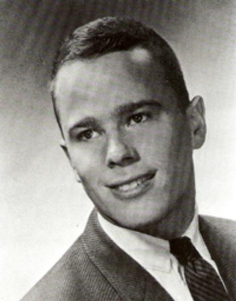 Private First Class Joseph William Crary photo dressed formally in a suit and tie, photographed in a classic studio style that suggests a school yearbook or a professional portrait from adolescence or early adulthood. 