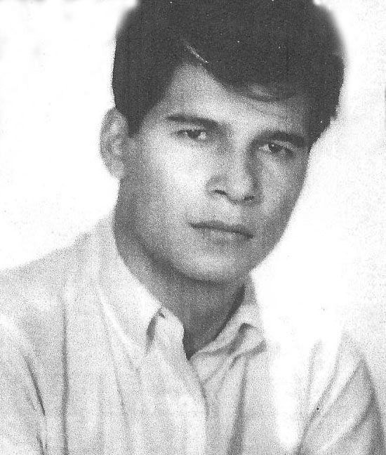 This portrait shows a young person photographed in a clean, formal studio style, the kind often used for school, employment, or identification photos