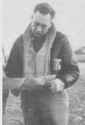 Major Edward C Tresemer in uniform looking down at paperwork standing photo