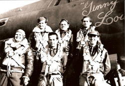 Technical Sergeant Elmer J Neis in uniform with several others in front of an airplane photo