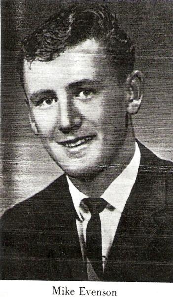 Michael A Evenson image in a formal black‑and‑white portrait. He is dressed in a suit jacket, white dress shirt, and a neatly tied necktie. 