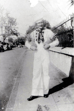 Fireman Second Class Frank P Bernard in uniform holding two pineapples black and white photo