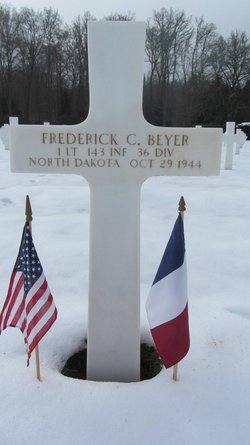 First Lieutenant Frederick C Beyer cross grave marker with small flags photo