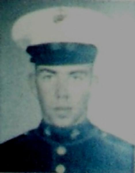This is a formal portrait of a United States Marine in dress uniform.