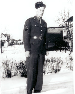 Technician Fifth Grade Glenn L Egge in uniform standing in snow black and white photo