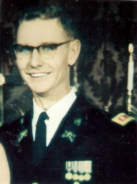 Major Virgil Raymond Greany photo in a formal military uniform, standing indoors in what appears to be a ceremonial or official setting. 