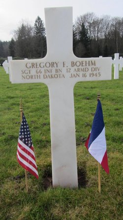 Sergeant Gregory F Boehm cross grave marker with small flags photo