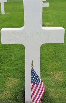 Corporal Henry H Raaum cross grave marker with small American flag photo