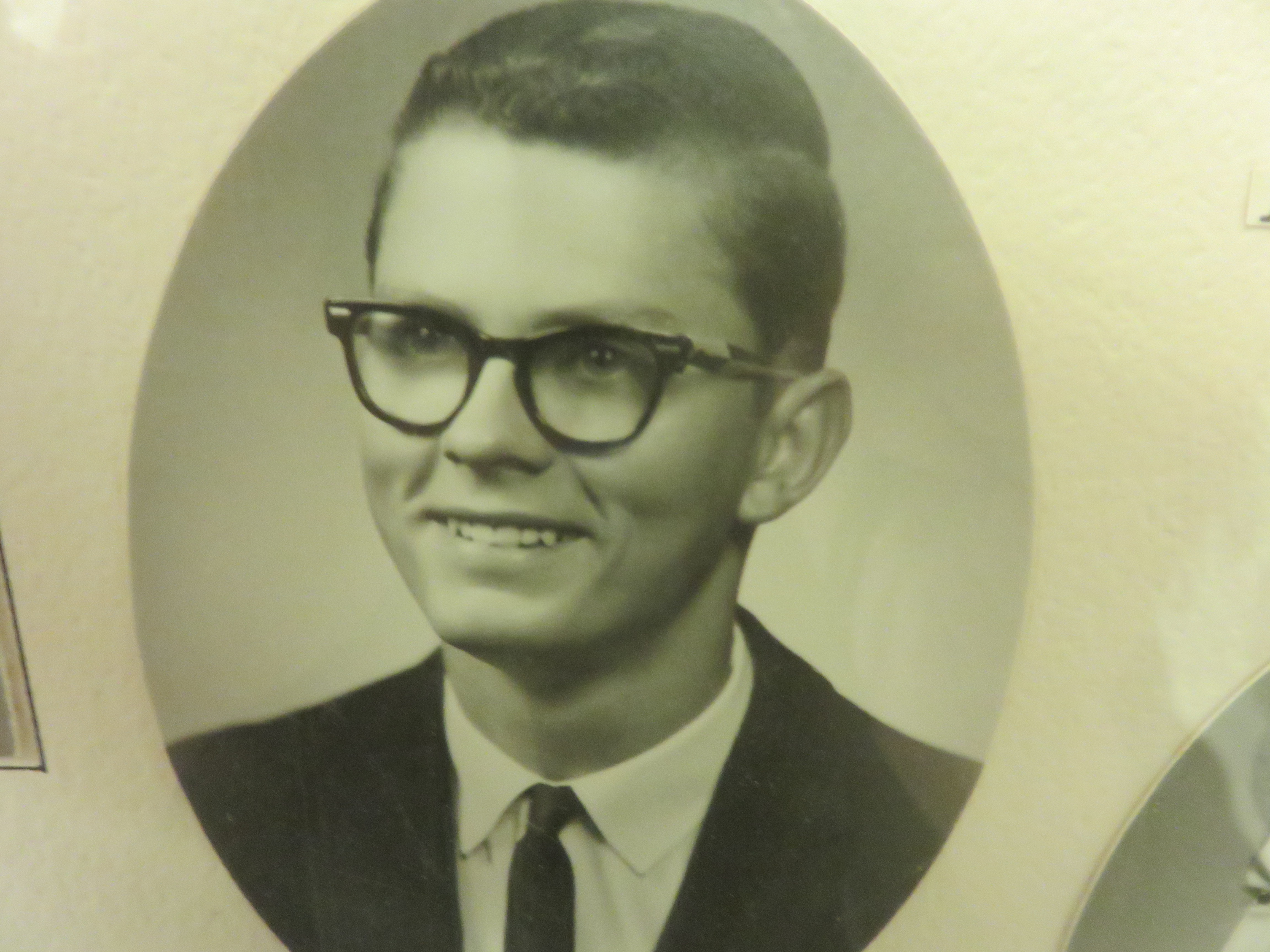 Gene Honcharoff photo in professional civilian attire, appears to a graduation photo or similar.
