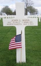 Private First Class cross grave marker with small American Flag photo