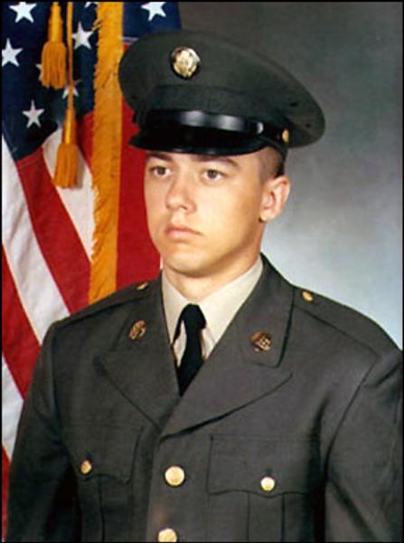 Sergeant David Francis Johnson photo in full dress uniform posed with the American Flag in what appears to be a studio setting.