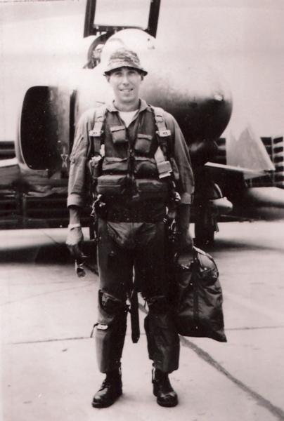 Wendell Keller black and white photo, he is standing confidently in front of a jet aircraft. 