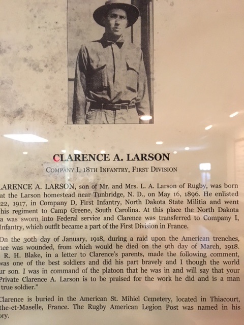 Memorial plaque for Clarence A. Larson, featuring a black-and-white portrait of him in a World War I military uniform and a detailed biographical inscription.