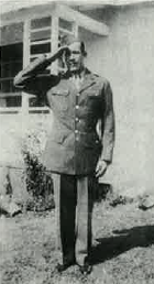 Private Lawrence George Gerving in uniform standing at attention outside photo