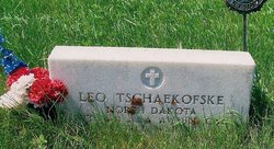 Private Leo Tschaekofske grave marker with red, white and blue flowers photo