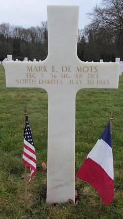 Technician Fifth Grade Mark E DeMots grave marker with small flags photo