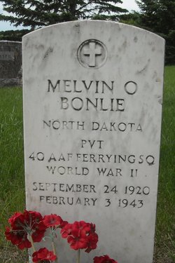 Private Melvin O Bonlie grave marker with flowers photo