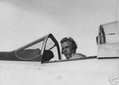 Photo of Leland Molland sitting in the cockpit of an airplane.