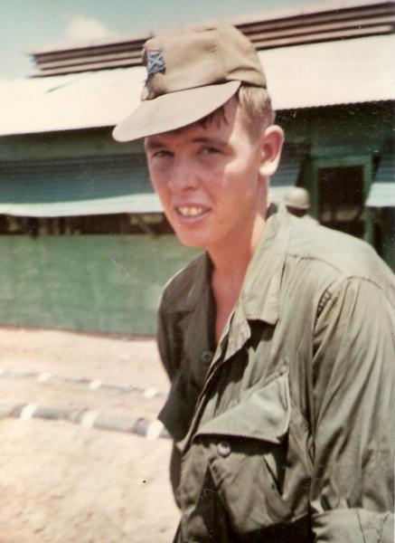 Thomas Narum photo standing in duty uniform outside.