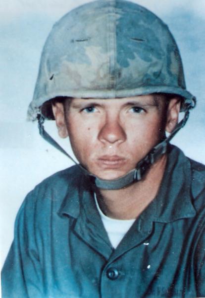 Dan Neuenschwander professional photo in military uniform with helmet.