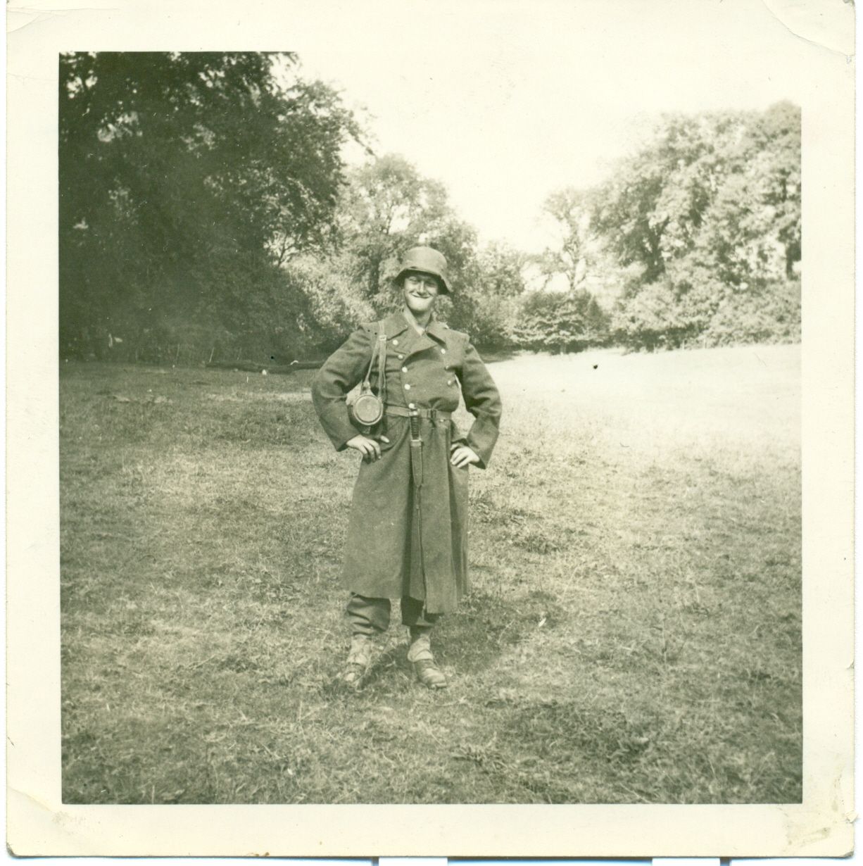Private Orville M Chilson in uniform standing in front of trees 