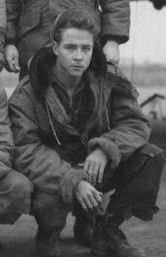Sergeant Peter J Farrell squatting down in uniform photo