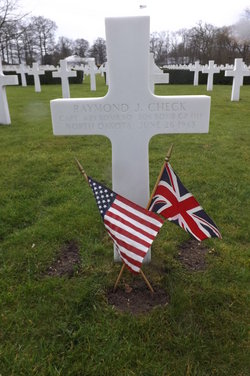 Captain Raymond J Check grave marker with small flags photo