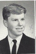 This is a black‑and‑white yearbook‑style portrait of a young man dressed in formal civilian clothing.