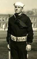 Motor Machinist's Mate Second Class Sidney A Loe in uniform standing outside photo