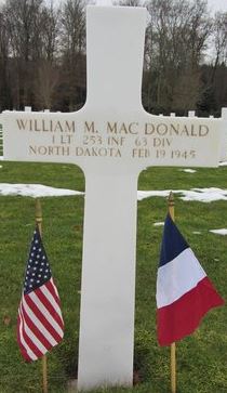 First Lieutenant William M MacDonald cross grave marker with small flags photo