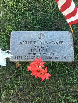 Private Arthur Wagner grave marker with small American flag and red flowers photo