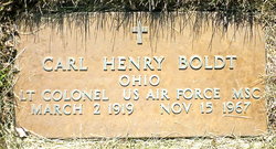 This is a bronze military grave marker honoring Carl Henry Boldt, set into a concrete frame and surrounded by grass.