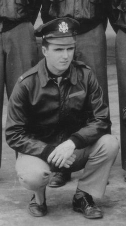 Charles G Nashold squatting down in front of others photo