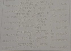 Seaman Second Class Darwin P Peterson name inscribed in memorial wall with several other names photo