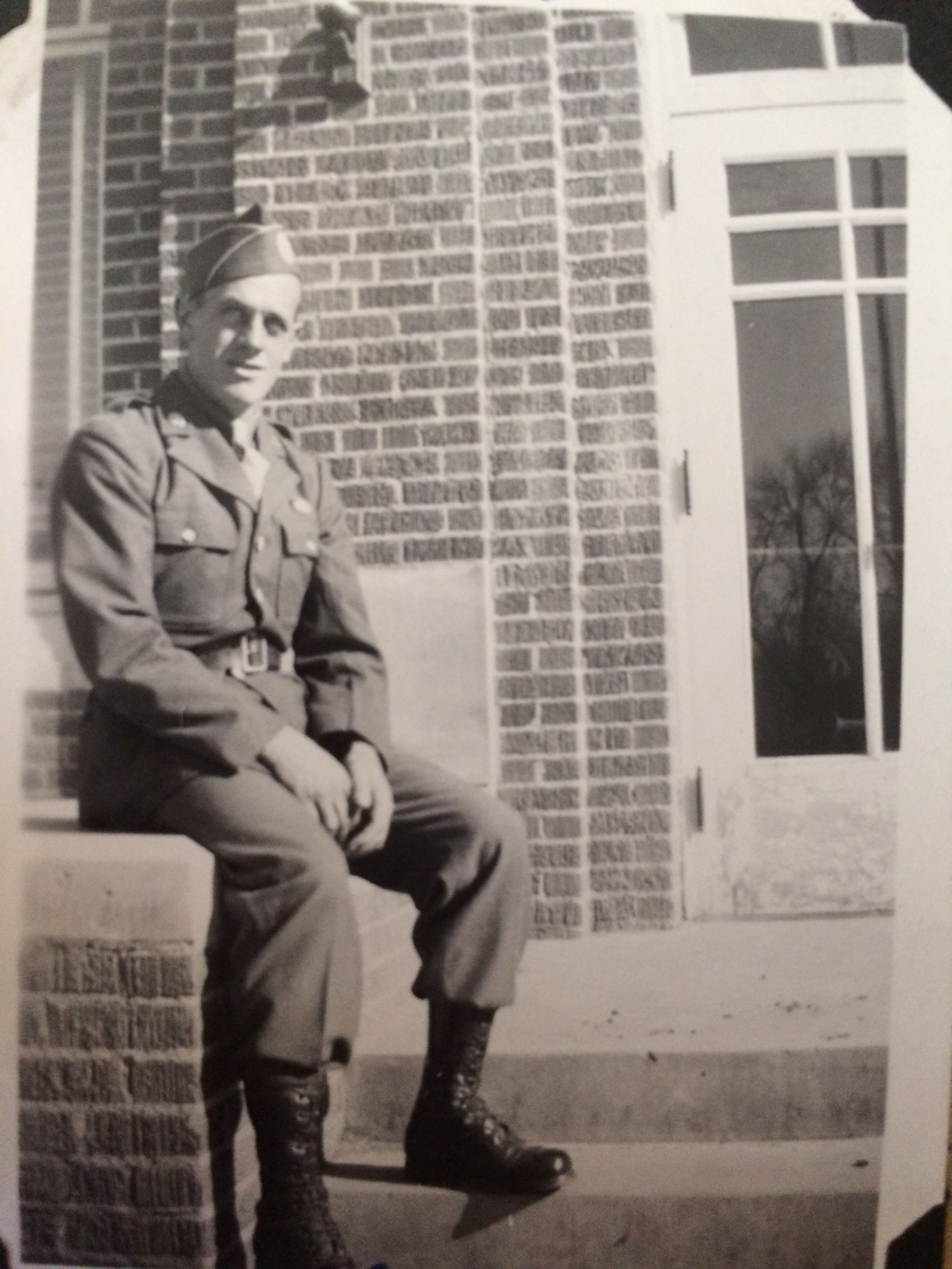 Sergeant Elvin T Kirkedahl in uniform sitting in front of a building