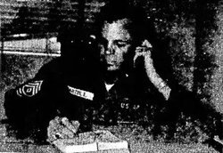 Erie Martin photo in uniform behind a desk.