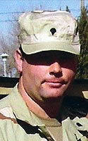 James J. Holmes wearing Army desert camouflage uniform.