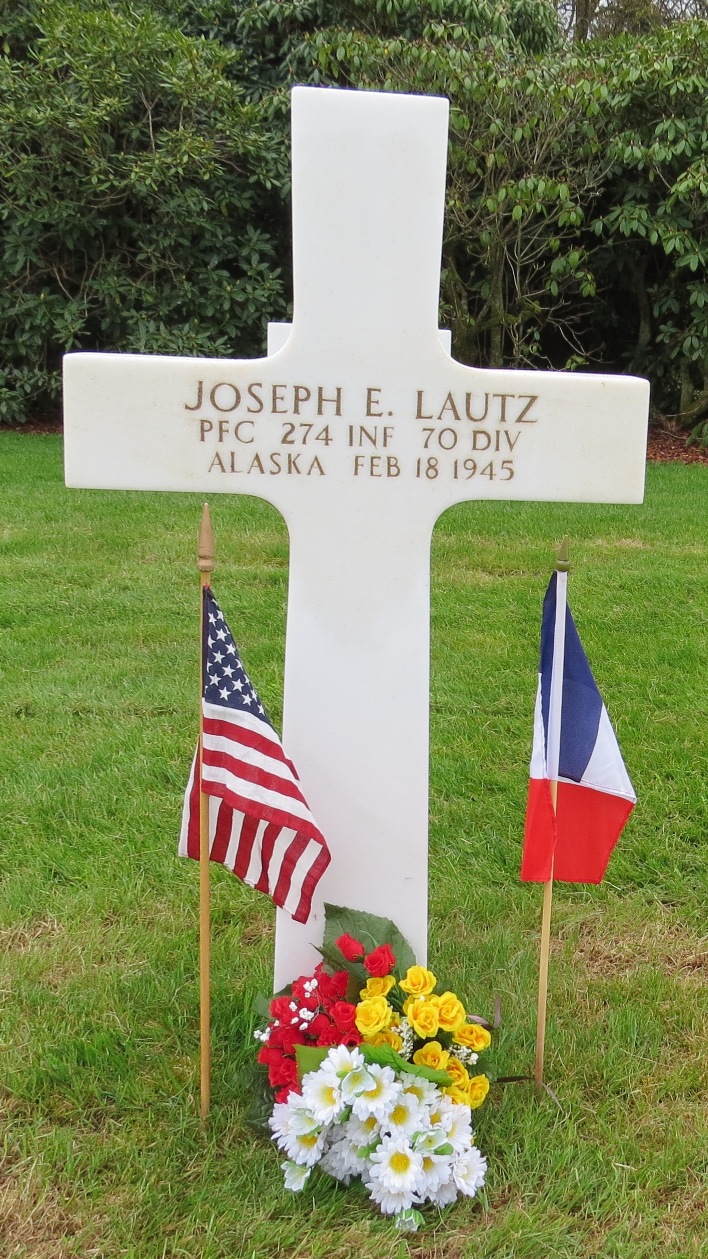 Private First Class Joseph E Lautz cross grave marker with flags and flowers photo