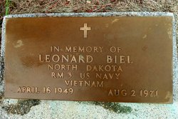 This is a bronze military grave marker honoring Leonard Biel, set into a concrete base and surrounded by grass. The design follows the standard style used for U.S. military memorial plaques.