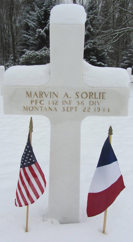 Private First Class Marvin A Sorlie cross grave marker with small flags photo