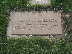 Merlyn A Fraedrick photograph showing a flat, ground‑level military grave marker made of light stone, set neatly within a patch of grass.